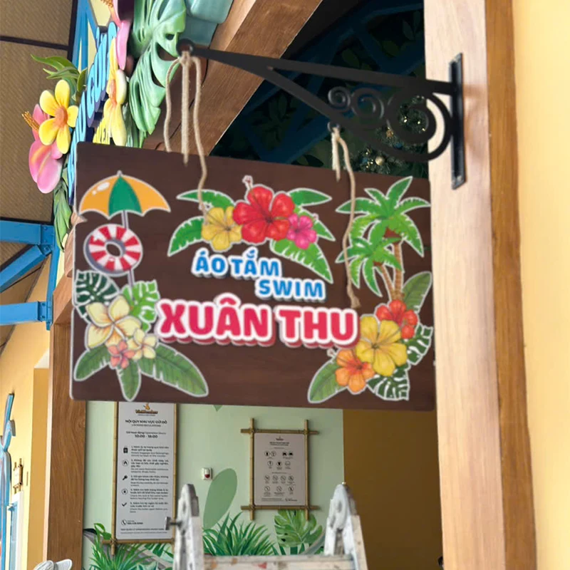 Bảng hiệu gỗ Xuân Thu thiết kế hoa văn màu sắc rực rỡ, phong cách dân dã, gần gũi.